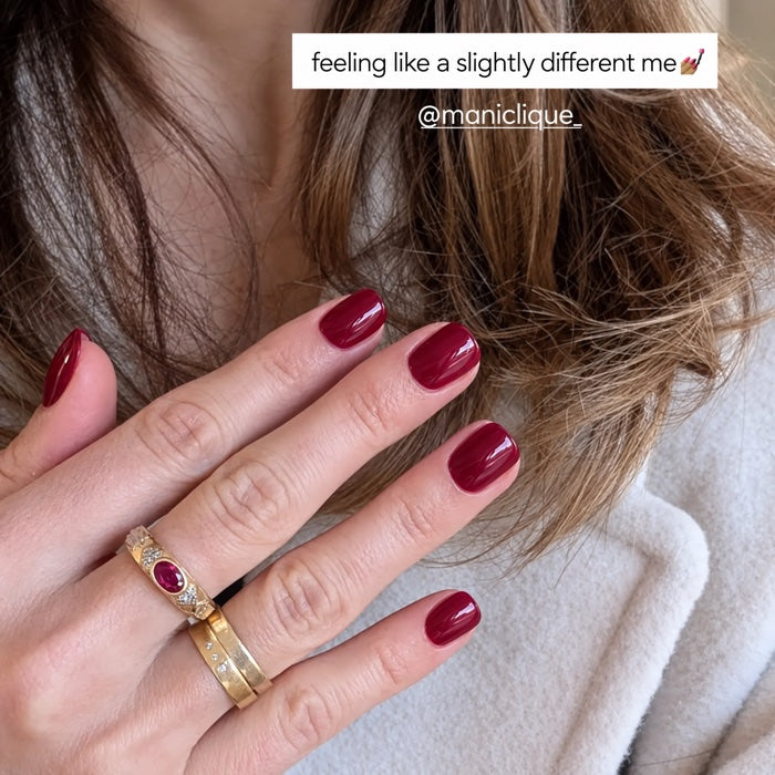 Berry manicure against white knit