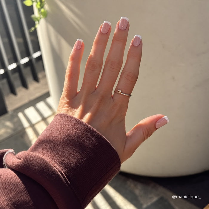 Square French manicure in sunlight